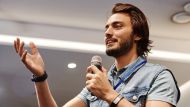 Man in Blue Denim Vest Holding Microphone