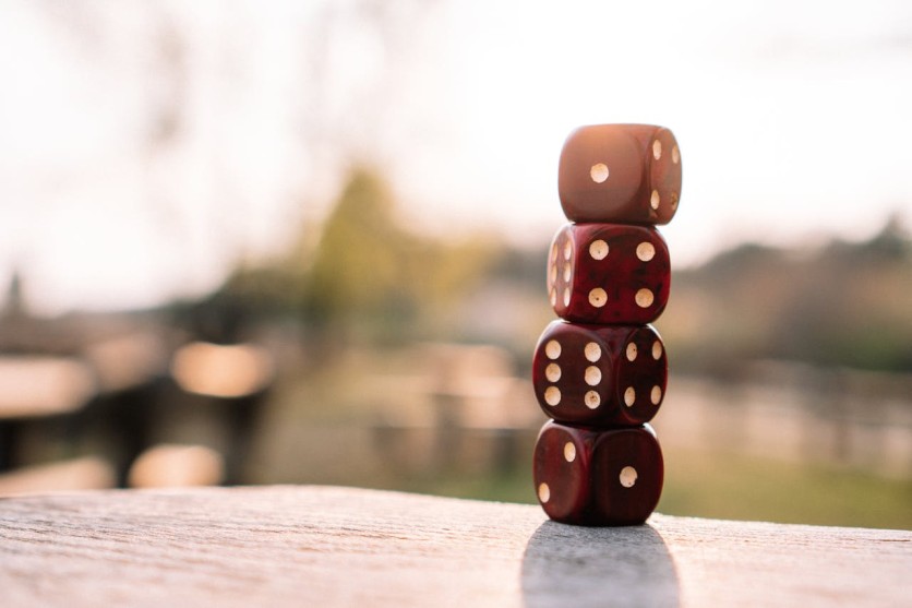 Red dice stacked on table on terrace