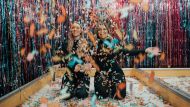 two women enjoying confetti